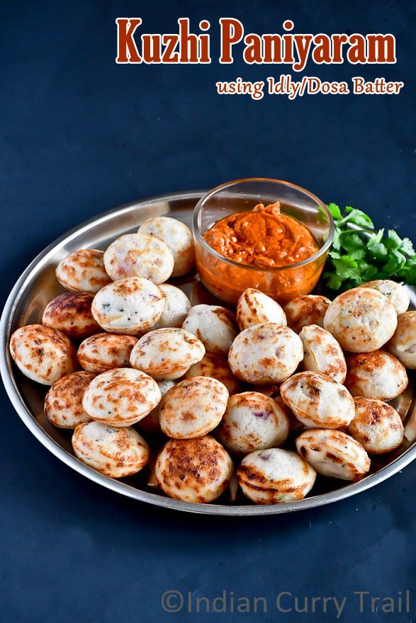 Kuzhi Paniyarams arranged in a plate with garlic chutney and coriander leaves