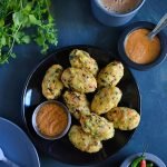 top view of corn meal dumplings with chutney in a bowl and a tea kept aside