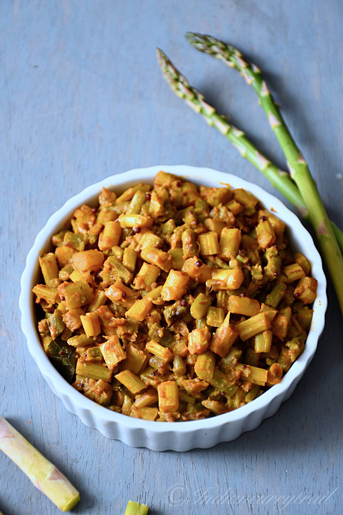 asparagus masala served in a bowl seasoned with mustard seeds and curry leaves
