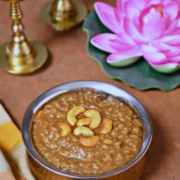 a picture showing a bowl of palm jaggery pongal with fried cashew nuts on top of it and traditional indian diya and lotus behind