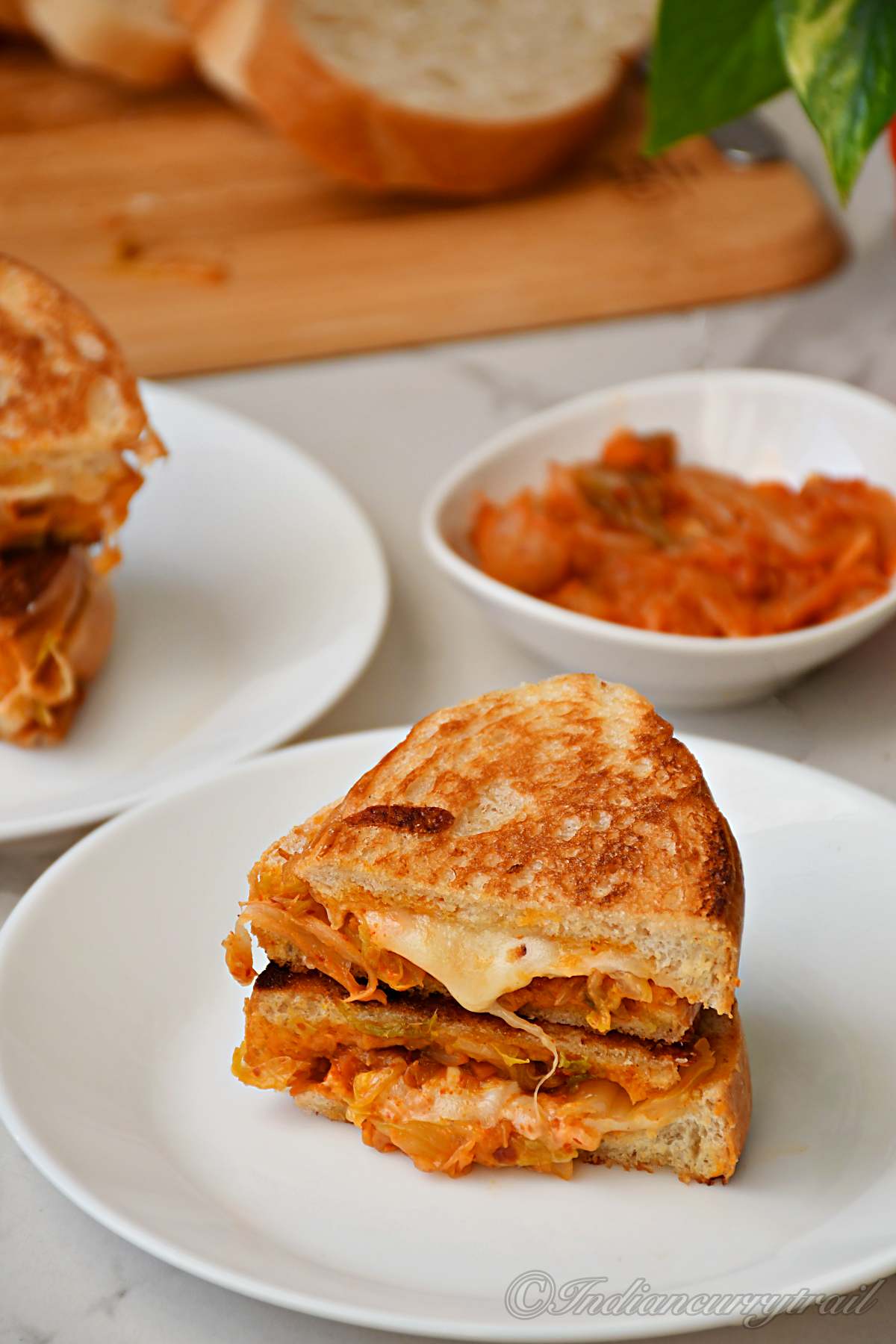 two slices of kimichi grilled cheese sandwich with cheese oozing out of it